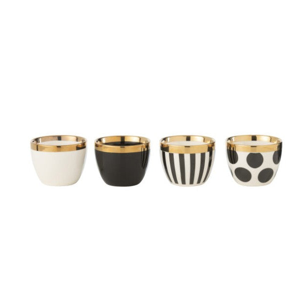 4 tasses avec différents motifs : 1 unie blanche, 1 unie noire, 1 rayée noir et blanc, 1 à pois noir sur fond blanc, l'ensemble avec une liseré doré.