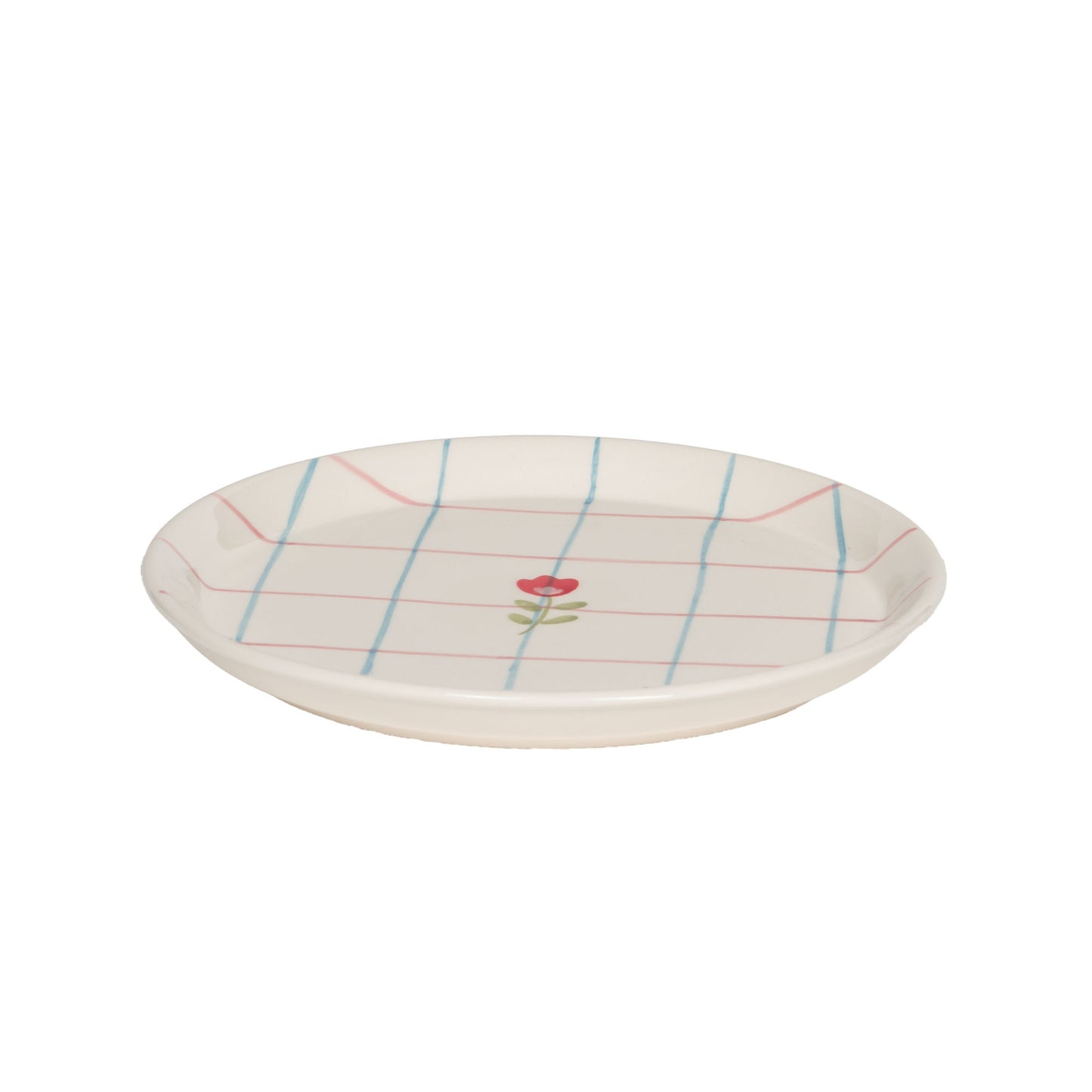 Assiette à dessert en grès avec un quadrillage fin bleu et rouge sur fond ivoire et un dessin de fleur centrale.