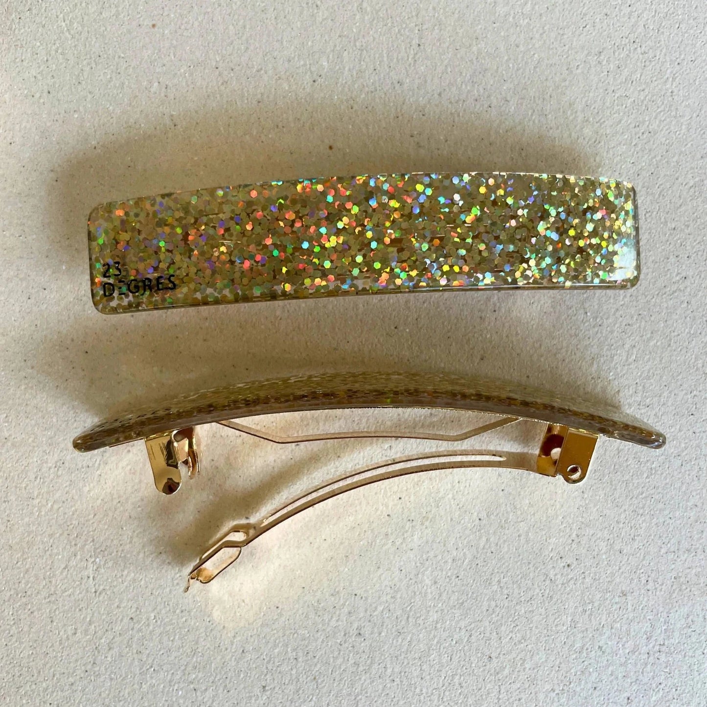 Barrette 9 cm de 23 degrés en acétate, coloris pailleté doré.
