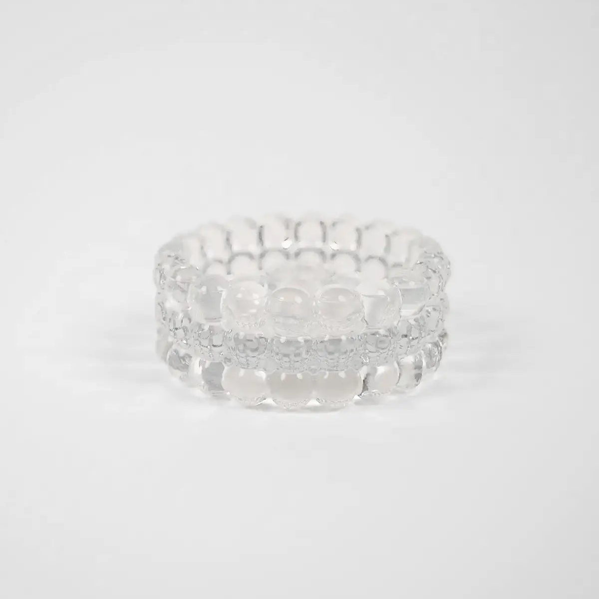 Bougeoir rond réversible en verre avec des petits bulles qui forment son contour. 