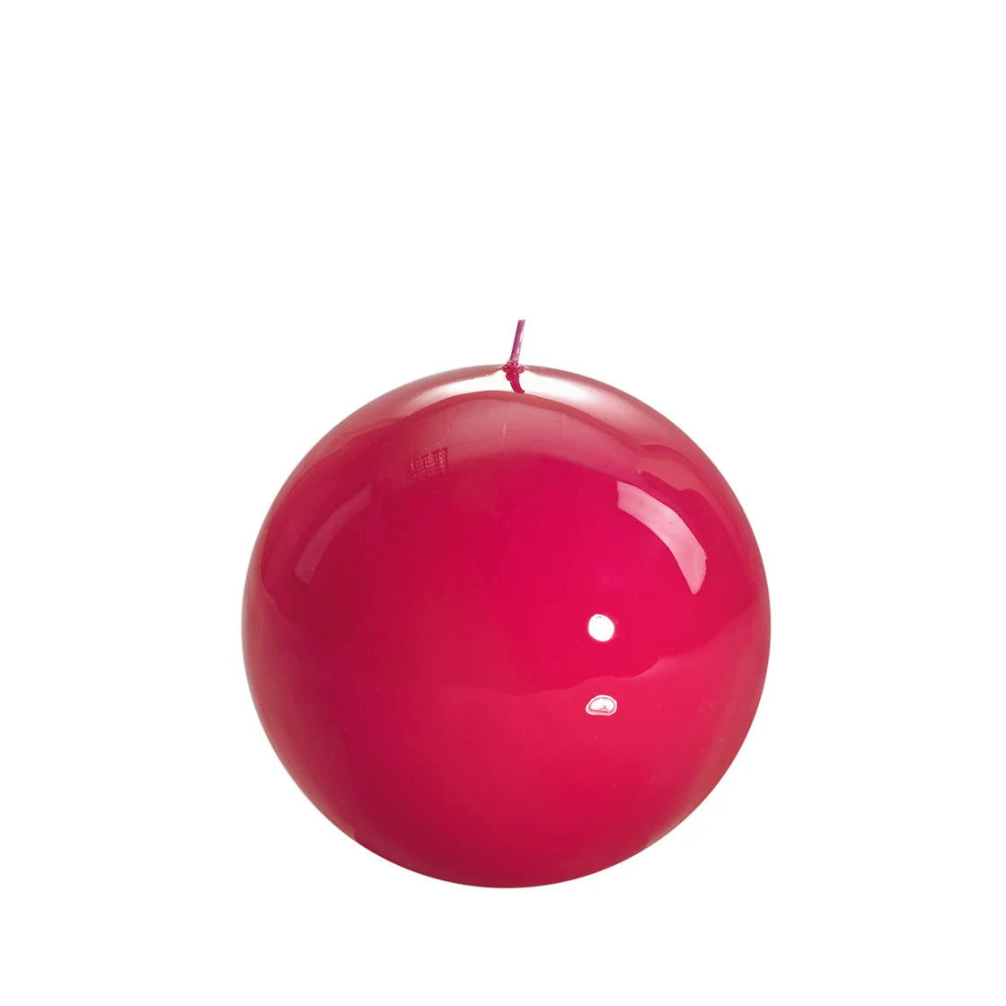 Bougie ronde brillante, coloris rose magenta.