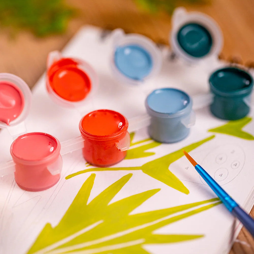 Détails du carnet, des pots de peinture et des pinceaux présents dans le carnet. 
