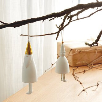 Cloches en porcelaine en forme de père Noël et de lutin minimalistes, à suspendre dans le sapin ou ailleurs.