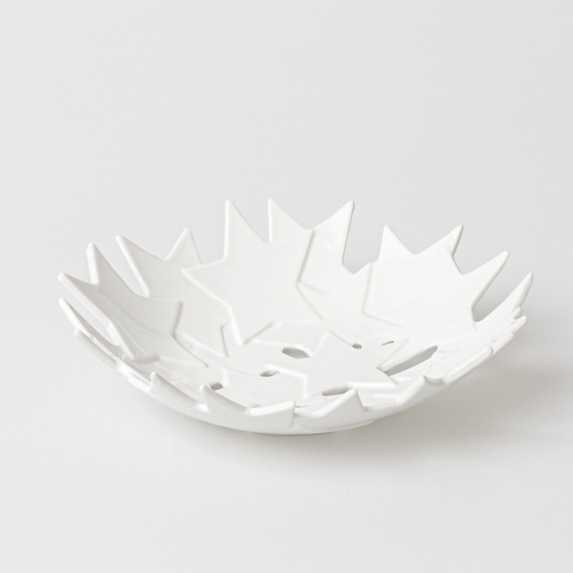 Coupe en porcelaine émaillée, formée par une constellation d’étoiles en léger relief assemblées entre elles.