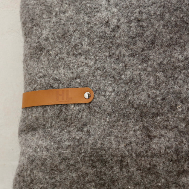 Coussin en laine feutrée gris foncé française avec un lien en cuir. 