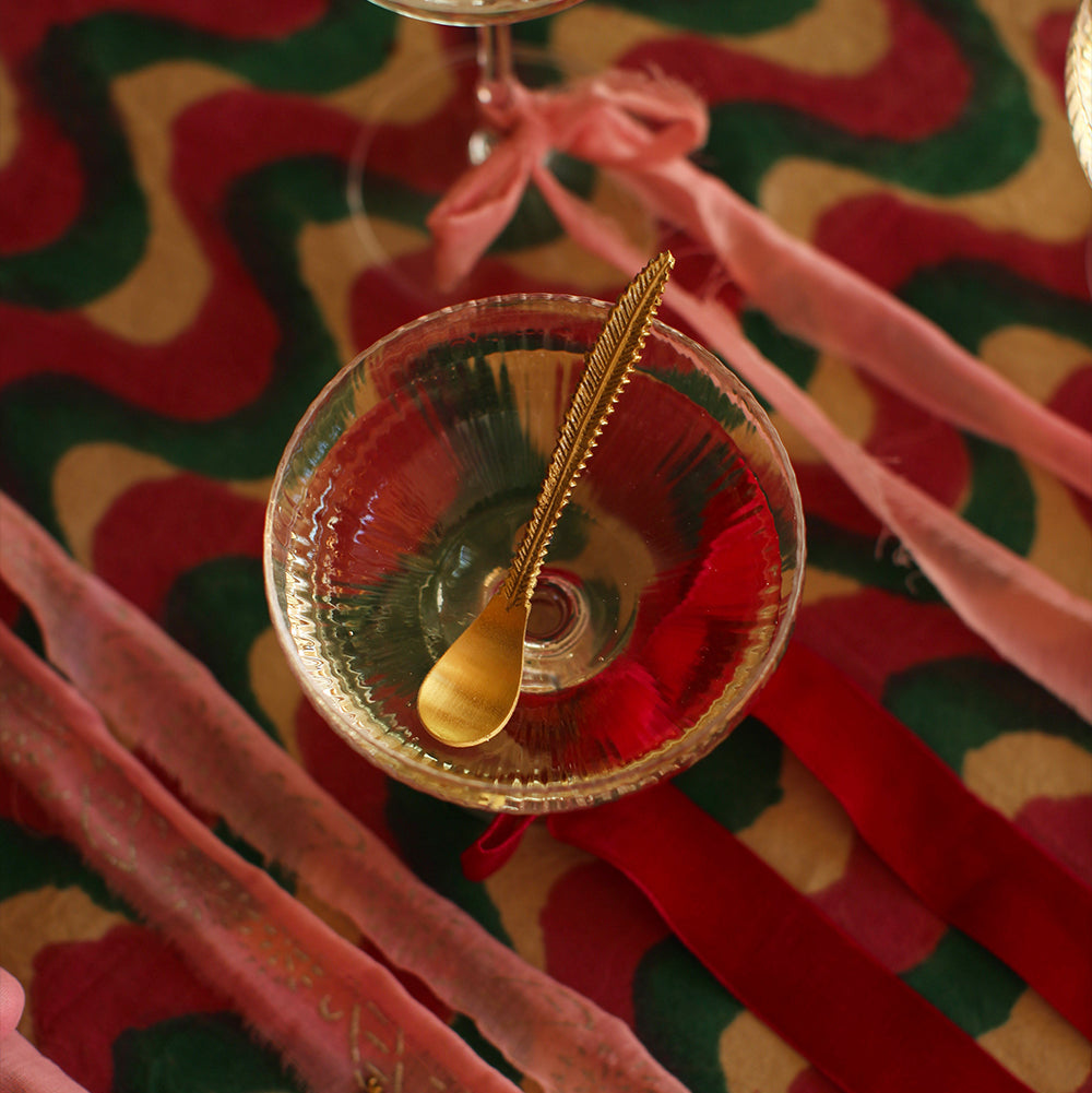 Set de 4 cuillères en laiton avec manche sculpté plume.