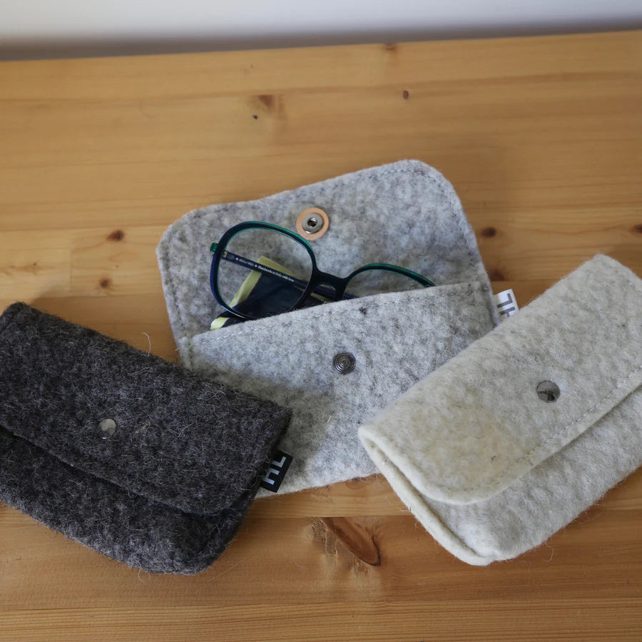Pochettes de rangement ou étuis à lunettes en laine feutrée française, coloris ivoire ou gris.