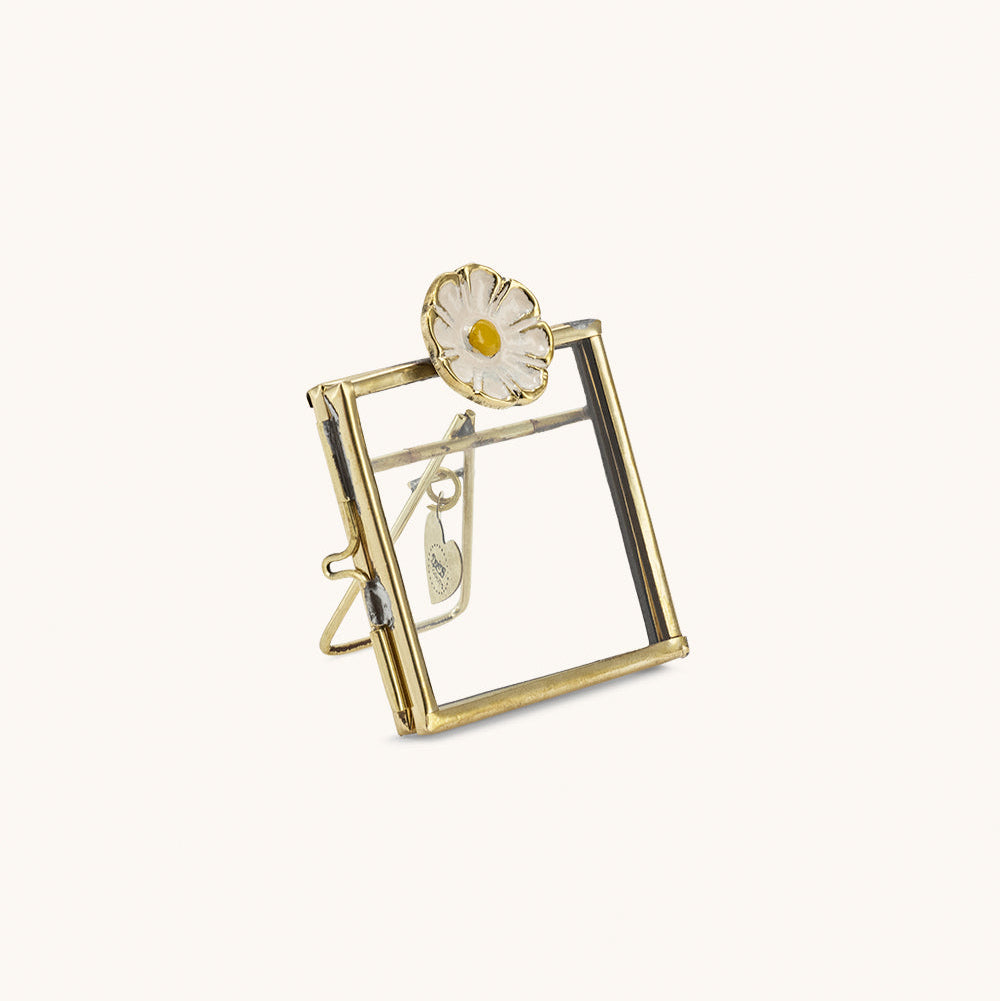 Mini cadre photo en laiton doré avec une marguerite blanche incrustée.