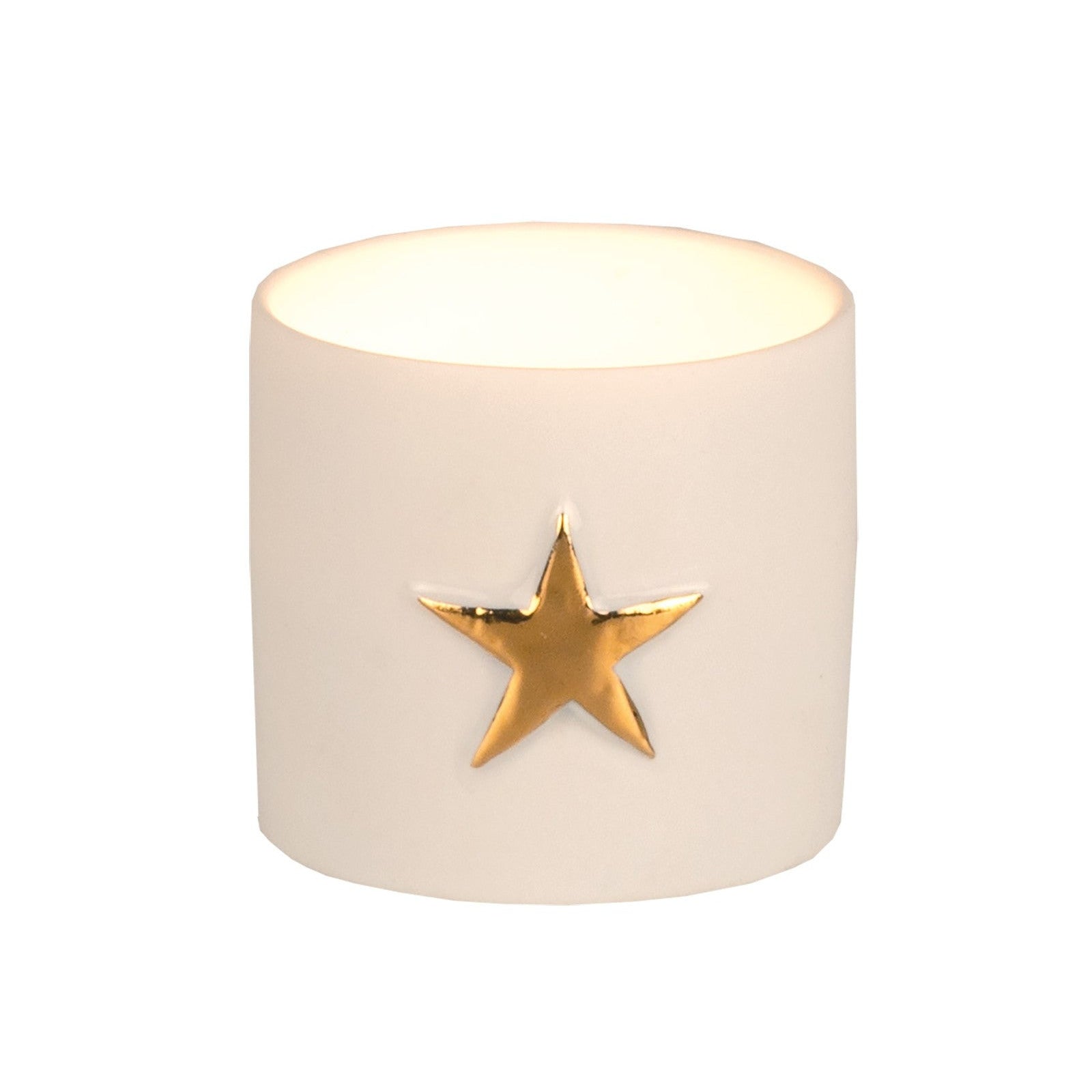 Petit photophore rond en porcelaine blanche avec une étoile doré, allumé.