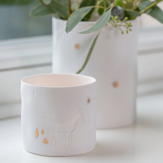 Photophores ronds en porcelaine avec détails gaufrés et dorés.