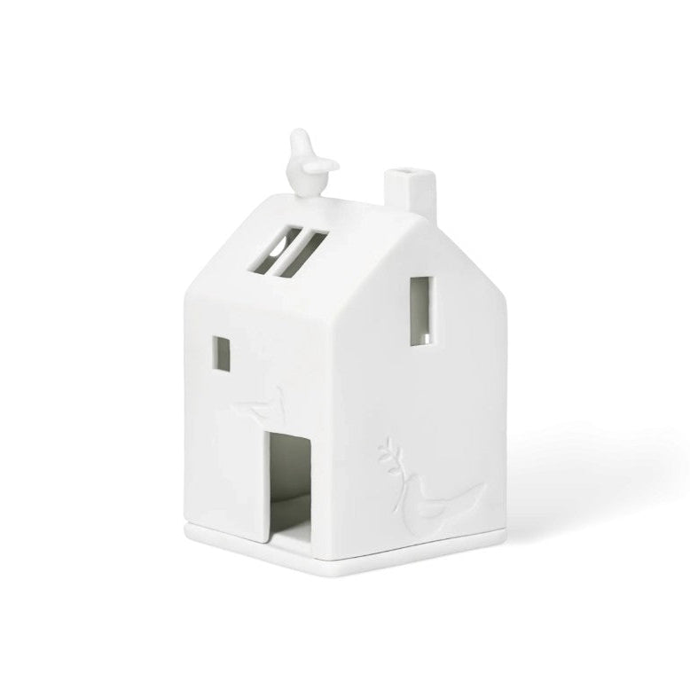 Photophore en porcelaine jourée en forme de maison, avec colombe sur le toit et en façade.