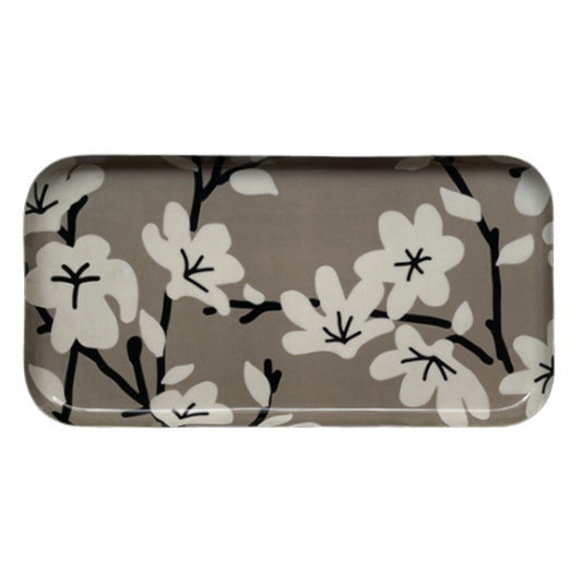 Plateau rectangulaire en métal avec des dessins de fleurs en blanc sur fond beige. 
