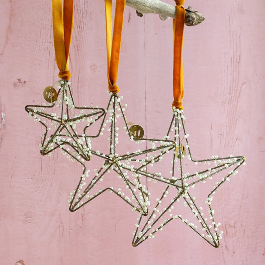 Set de 3 étoiles perlées à suspendre en décoration de Noël, de trois formats différents.