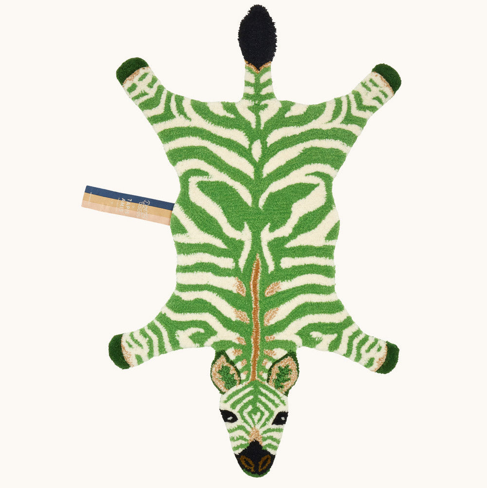 Petit tapis en laine en forme de zèbre vert.