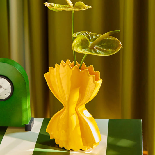 Vase en céramique en forme de faraflle jaune.