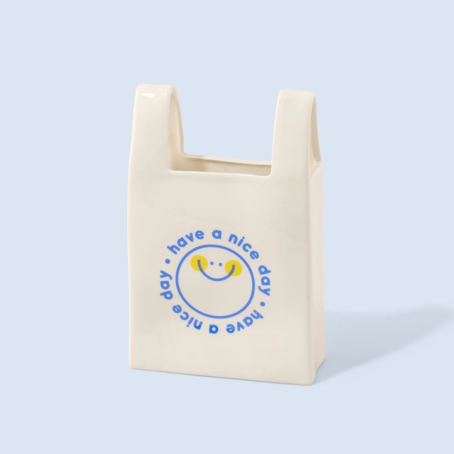 Vase en céramique en forme de sac plastique blanc avec un message en bleu "Have a Nice Day"
