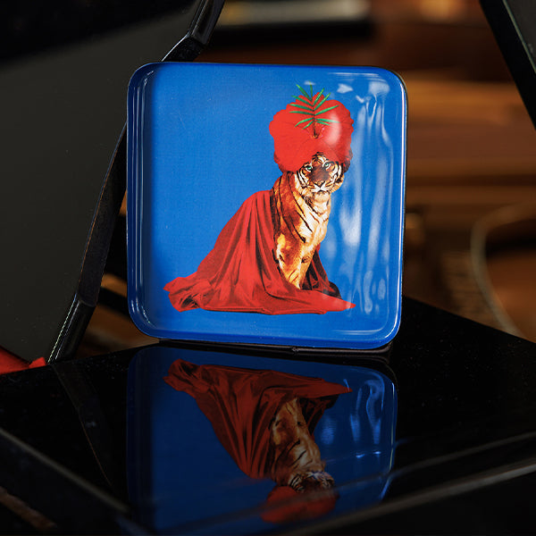 Vide-poche carré en métal verni, modèle Fakir, fond bleu.