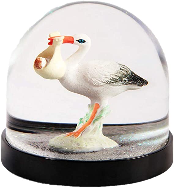 Boule à neige Klevring, avec une cigogne, sous des paillettes blanches.